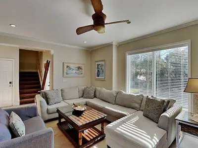 a living room with a couch and a table at Lazy River Retreat in Panama City Beach