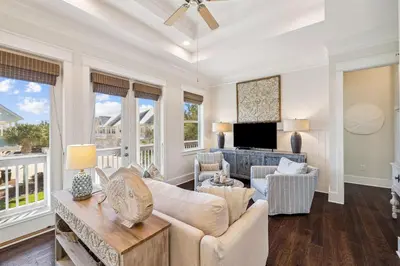 a living room with white furniture and windows at Sun and Sand for 6 - 167 Milestone Dr Unit C in Inlet Beach