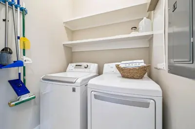a small laundry room with a washer and dryer at Sun and Sand for 6 - 167 Milestone Dr Unit C in Inlet Beach