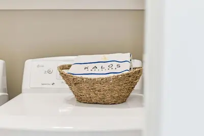 a basket of towels sitting on top of a washing machine at Sun and Sand for 6 - 167 Milestone Dr Unit C in Inlet Beach