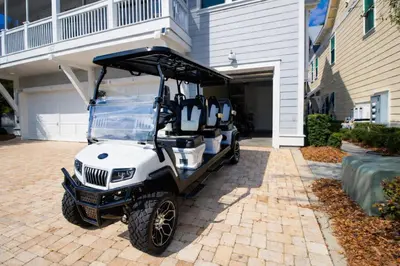 a golf cart parked in front of a building at Sun and Sand for 6 - 167 Milestone Dr Unit C in Inlet Beach