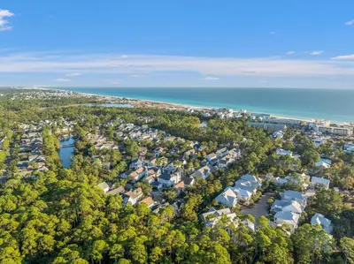 an aerial view of a town with the ocean at Sea D’Light: 3BR Beach Home Sleeps 10 with 4 Bikes in Watersound West in Santa Rosa Beach