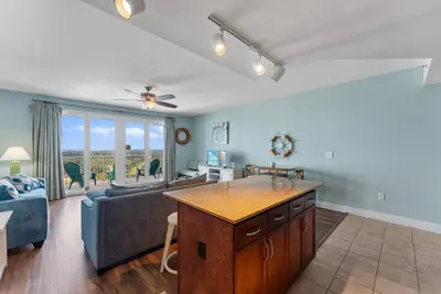 a living room with a couch and a table at Beach Resort Condo with 5 Pools! Steps to Beach! by Dolce Vita Getaways PCB in Panama City Beach