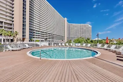 a swimming pool in front of a large building at Beach Resort Condo with 5 Pools! Steps to Beach! by Dolce Vita Getaways PCB in Panama City Beach