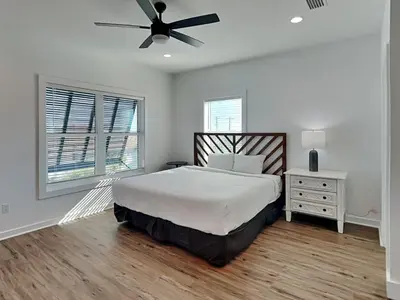 a bedroom with a bed and a ceiling fan at Sunset on Snapper C in Panama City Beach