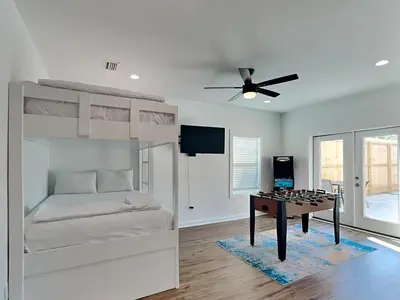 a bedroom with a bunk bed and a desk in it at Sunset on Snapper C in Panama City Beach