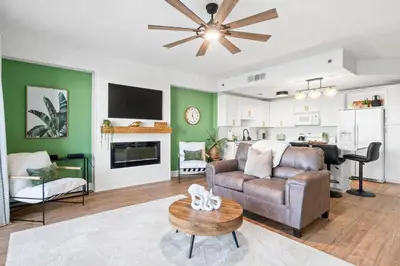 a living room with a couch and a table at Relaxing 2nd-Floor Laketown Wharf Condo Overlooking the Lake in Panama City Beach
