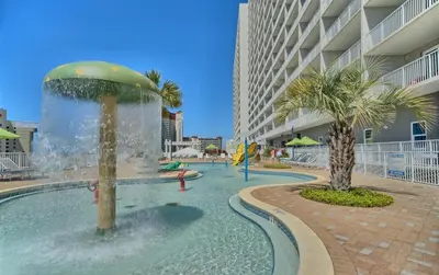 a swimming pool with a fountain in the middle of a building at Relaxing 2nd-Floor Laketown Wharf Condo Overlooking the Lake in Panama City Beach
