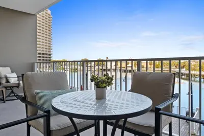 a table and chairs on a balcony with a view at Relaxing 2nd-Floor Laketown Wharf Condo Overlooking the Lake in Panama City Beach