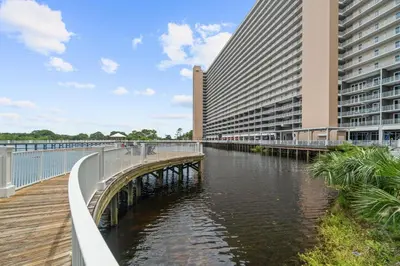 a bridge over a river in front of a building at Relaxing 2nd-Floor Laketown Wharf Condo Overlooking the Lake in Panama City Beach