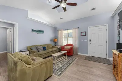 a living room with two couches and a tv at Walk to Emerald Beach,Cozy Coastal Getaway in Panama City Beach