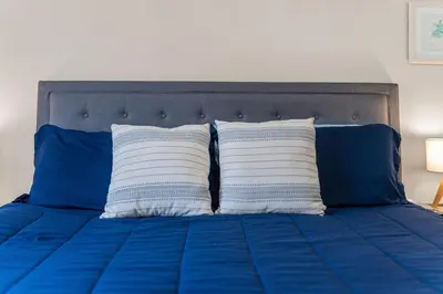 a blue bed with two white pillows on it at Walk to Emerald Beach,Cozy Coastal Getaway in Panama City Beach