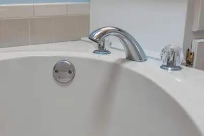 a white bathroom sink with a silver faucet at Walk to Emerald Beach,Cozy Coastal Getaway in Panama City Beach