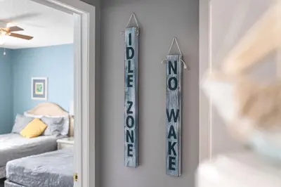 a mirror hanging on a wall in a room at Walk to Emerald Beach,Cozy Coastal Getaway in Panama City Beach