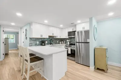 a kitchen with white cabinets and a white counter top at Charming Beachfront Condo with Stunning Views in Panama City Beach