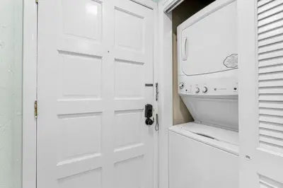 a white door in a kitchen with a dishwasher at Charming Beachfront Condo with Stunning Views in Panama City Beach