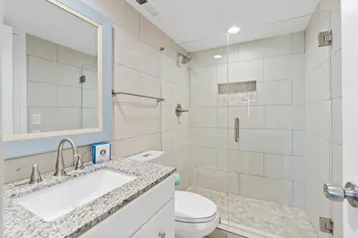 a white bathroom with a sink and a toilet at Book Me Baby! License to Chill One Seagrove Place in Seagrove Beach