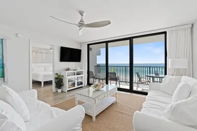 a living room with white furniture and a view of the ocean at Book Me Baby! License to Chill One Seagrove Place in Seagrove Beach
