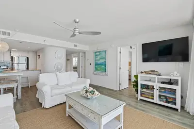 a living room with a white couch and a table at Book Me Baby! License to Chill One Seagrove Place in Seagrove Beach