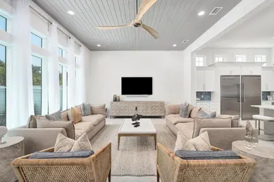 a living room with a couch and a tv at Oz by The Sea in Inlet Beach