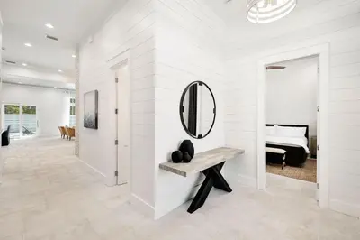a white room with a mirror and a bench at Oz by The Sea in Inlet Beach