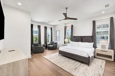 a bedroom with a bed and a living room at Oz by The Sea in Inlet Beach