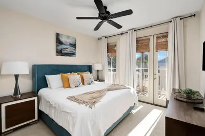 a bedroom with a bed and a ceiling fan at North Winston Villa in Inlet Beach
