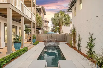 a backyard with a pool and a house at North Winston Villa in Inlet Beach