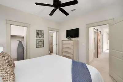 a bedroom with a bed and a ceiling fan at North Winston Villa in Inlet Beach