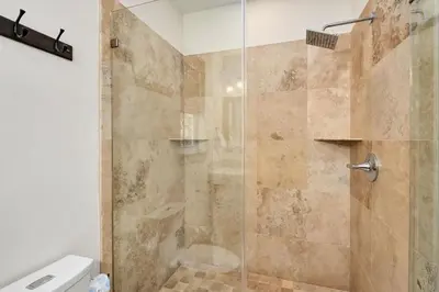 a bathroom with a shower with a glass door at North Winston Villa in Inlet Beach
