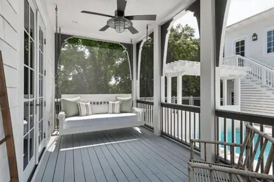 a porch with a couch and a ceiling fan at Traveler's Rest in Inlet Beach