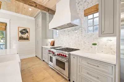a kitchen with white cabinets and a stove at Traveler's Rest in Inlet Beach