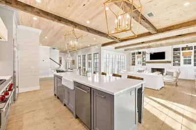 a kitchen with a large island and a living room at Traveler's Rest in Inlet Beach