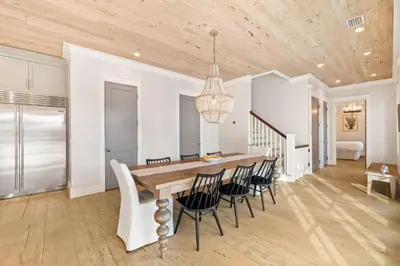 a dining room with a wooden table and chairs at Traveler's Rest in Inlet Beach