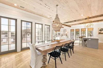 a kitchen and dining room with a large wooden table and chairs at Traveler's Rest in Inlet Beach