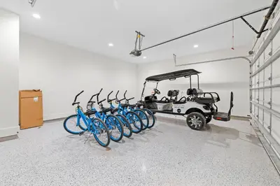 a group of bikes parked in a room with a golf cart at Traveler's Rest in Inlet Beach