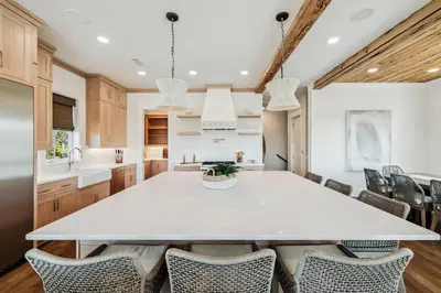 a kitchen with a large white table and chairs at Crabstar in Inlet Beach