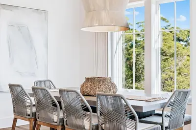 a dining room with a table and six chairs at Crabstar in Inlet Beach