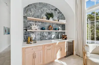 a kitchen with a sink and a stone wall at Crabstar in Inlet Beach