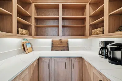 a kitchen with wooden cabinets and white counter tops at Crabstar in Inlet Beach