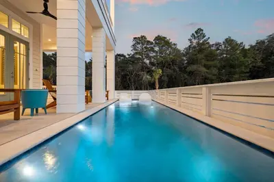 a swimming pool in the backyard of a house at Crabstar in Inlet Beach