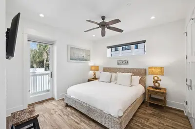 a bedroom with a bed and a ceiling fan at Emerald Breeze in Inlet Beach