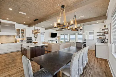 a kitchen and dining room with a table and chairs at Emerald Breeze in Inlet Beach