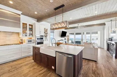 a large kitchen with white cabinets and a large island at Emerald Breeze in Inlet Beach
