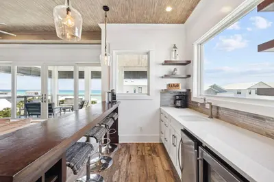 a kitchen with a large counter with a view of the ocean at Emerald Breeze in Inlet Beach
