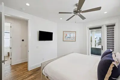 a bedroom with a bed and a ceiling fan at Emerald Breeze in Inlet Beach