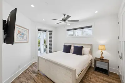 a bedroom with a bed and a ceiling fan at Emerald Breeze in Inlet Beach