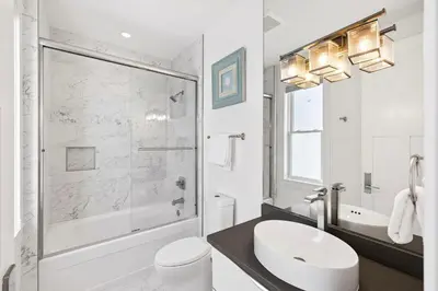 a bathroom with a shower and a sink and a toilet at Emerald Breeze in Inlet Beach