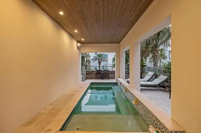 a swimming pool in the middle of a house at Emerald Breeze in Inlet Beach