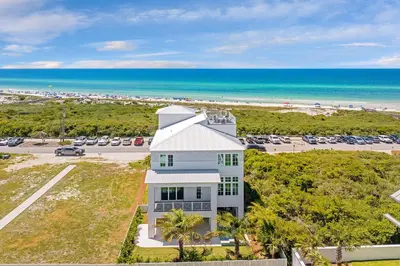 an aerial view of a white house and the beach at Marisol 30A in Inlet Beach